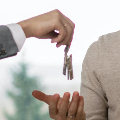 Image of house buyer being handed keys to their new home